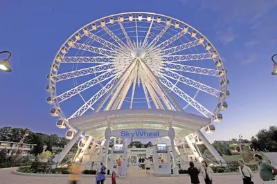 a large ferris wheel with people standing around it at Adorable 2-bedroom unit with jacuzzi beside falls in Niagara Falls