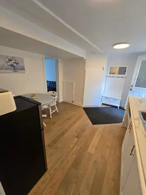 a kitchen and a living room with a table at Private 2-Bedroom Minutes From Trent University in Peterborough