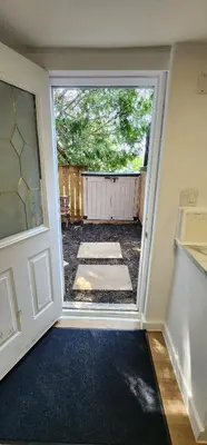 an open door to a yard with a patio at Private 2-Bedroom Minutes From Trent University in Peterborough