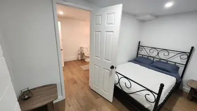 a small bedroom with a black and white bed at Private 2-Bedroom Minutes From Trent University in Peterborough