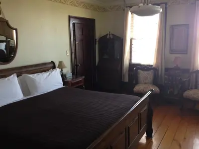 a bedroom with a large bed and a window at Stevenson Farms-Harvest Spa B & B in Alliston