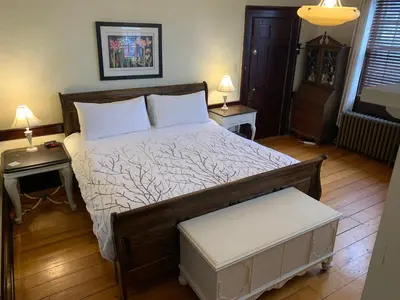 a bedroom with a bed with two tables and two lamps at Stevenson Farms-Harvest Spa B & B in Alliston