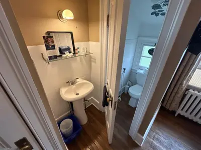 a small bathroom with a sink and a toilet at Stevenson Farms-Harvest Spa B & B in Alliston