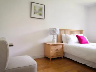 a bedroom with a bed and a lamp on a night stand at spacious and bright house in Toronto