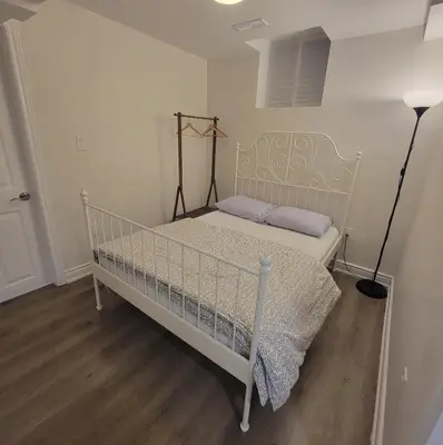 a white bed in a white room with a lamp at Lake-Walk House 3 Bed 2 Bath Apt in Hamilton