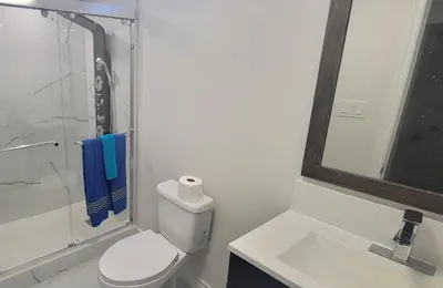 a bathroom with a toilet and a sink and a shower at Lake-Walk House 3 Bed 2 Bath Apt in Hamilton
