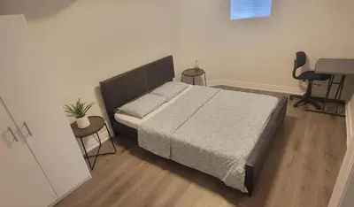 a bedroom with a bed and a desk and a chair at Lake-Walk House 3 Bed 2 Bath Apt in Hamilton