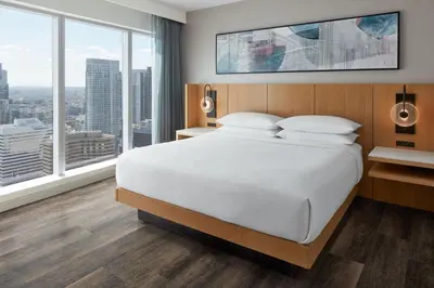 a bedroom with a large white bed and large windows at Delta Hotels by Marriott Toronto in Toronto