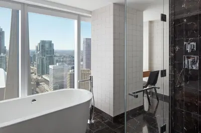 a bathroom with a bath tub and a window at Delta Hotels by Marriott Toronto in Toronto