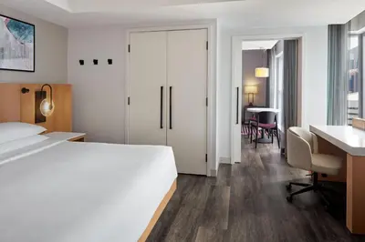 a hotel room with a large white bed and a desk at Delta Hotels by Marriott Toronto in Toronto