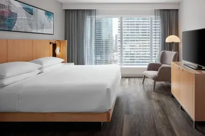 a hotel room with a large bed and a television at Delta Hotels by Marriott Toronto in Toronto