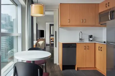 a kitchen with a table and chairs and a kitchen with a window at Delta Hotels by Marriott Toronto in Toronto