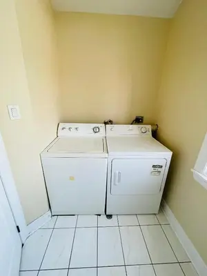 a laundry room with a washer and dryer at Jazzy Home Stay in Mississauga