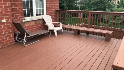 a wooden deck with two chairs and a bench at Jazzy Home Stay in Mississauga