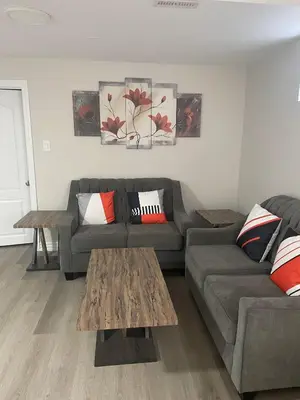 a living room with a couch and a table at Brand New, cozy 2 Bdrm Bsmnt Apt in Mississauga