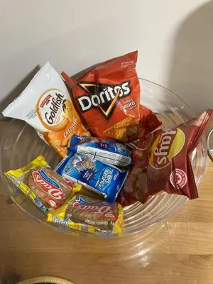 a bowl of chips and other snacks on a table at Brand New, cozy 2 Bdrm Bsmnt Apt in Mississauga