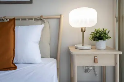 a lamp on a side table next to a bed at Work From home with Parking WIFI and CN Tower View in Toronto