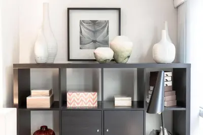 a shelf with vases and a picture and a lamp at LUX 2BR 1BA Steps to CN Tower W Parking included in Toronto