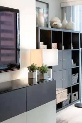 a living room with a entertainment center with plants on it at LUX 2BR 1BA Steps to CN Tower W Parking included in Toronto