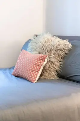 a stuffed animal sitting on a bed with a pillow at LUX 2BR 1BA Steps to CN Tower W Parking included in Toronto