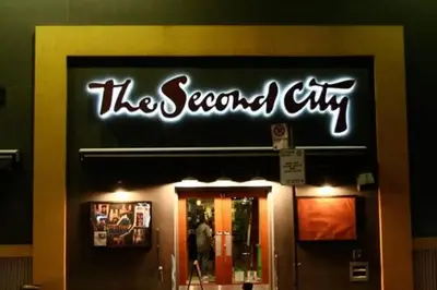 a sign for the second city on the front of a store at LUX 2BR 1BA Steps to CN Tower W Parking included in Toronto
