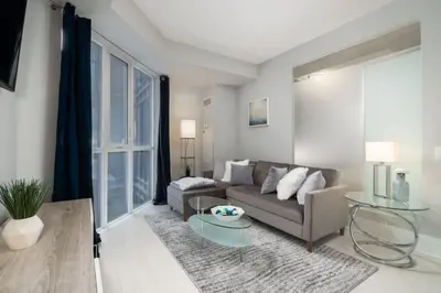 a living room with a couch and a table at Modern Condo 1 BD 1BA with a Sofabed Downtown in Toronto
