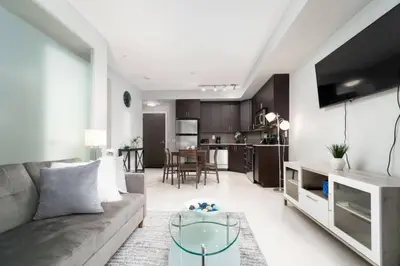 a living room with a couch and a table at Modern Condo 1 BD 1BA with a Sofabed Downtown in Toronto