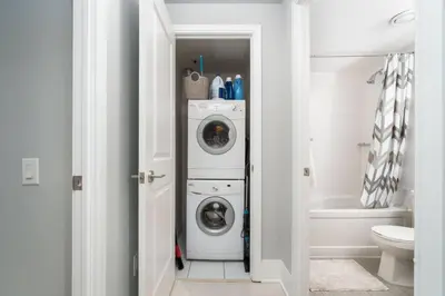 a laundry room with a washer and dryer at Modern Condo 1 BD 1BA with a Sofabed Downtown in Toronto