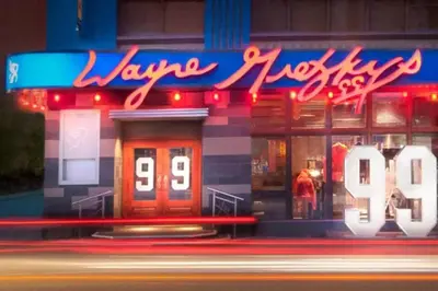 a building with a neon sign in front of it at 1 BR Furnished Condo with Balcony across CN Tower in Toronto