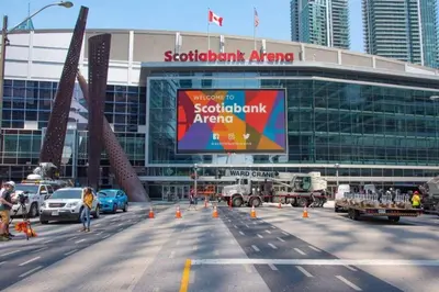 a parking lot in front of a soft rock arena at 1 BR Furnished Condo with Balcony across CN Tower in Toronto