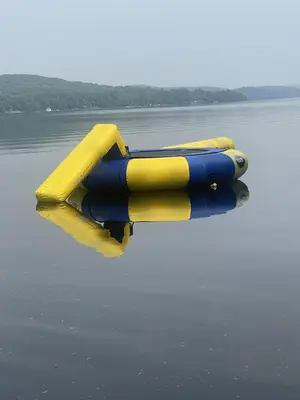 a yellow and blue object floating in the water at Getaway Cottage LAKE FRONT Muskoka Room Kayaks in Dwight