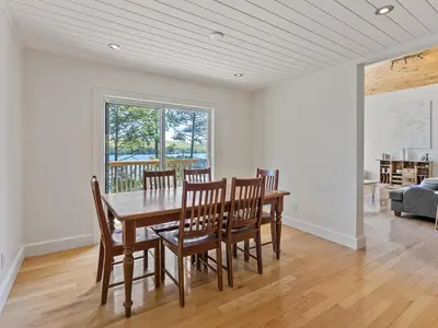 a dining room with a wooden table and chairs at Getaway Cottage LAKE FRONT Muskoka Room Kayaks in Dwight