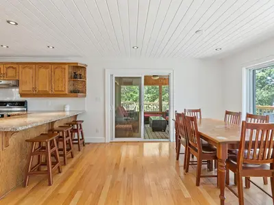 a kitchen with a wooden table and chairs at Getaway Cottage LAKE FRONT Muskoka Room Kayaks in Dwight