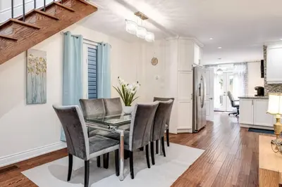 a dining room with a table and chairs at 3BR Casa close to Woodbine Beach with deck area and WFH in Toronto