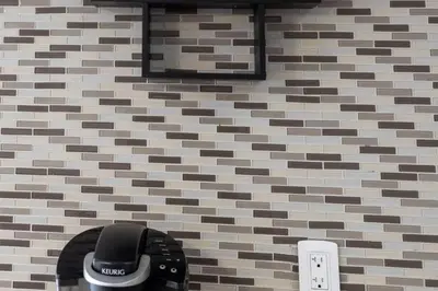 a pay phone on a wall with a brick wall at 3BR Casa close to Woodbine Beach with deck area and WFH in Toronto