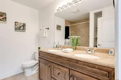 a bathroom with two sinks and a toilet at 3BR Casa close to Woodbine Beach with deck area and WFH in Toronto