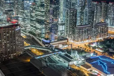 a view of a city at night at Luxury CN Tower View King Bed Balcony FREE PARK in Toronto