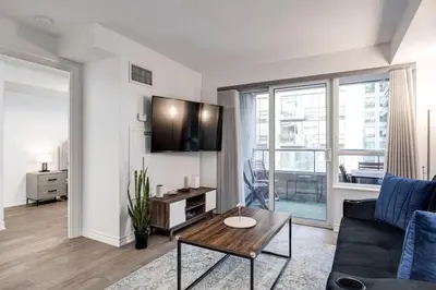 a living room with a couch and a table at Urban APT with Highspeed WiFi Near shopping malls in Toronto
