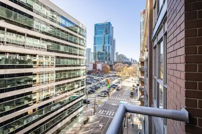 a view of a busy city street with buildings at Urban APT with Highspeed WiFi Near shopping malls in Toronto