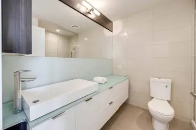 a white bathroom with a sink and a toilet at Exec 2BR 2BTH w Million Dollar View of CN tower in Toronto
