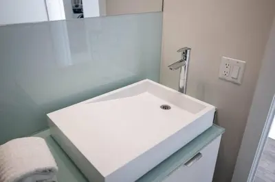 a white sink in a bathroom with a mirror at Exec 2BR 2BTH w Million Dollar View of CN tower in Toronto