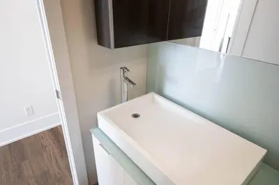 a bathroom with a white sink and a cabinet at Exec 2BR 2BTH w Million Dollar View of CN tower in Toronto