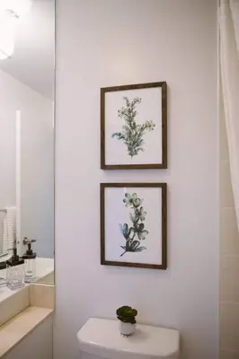 a bathroom with three pictures on the wall above a toilet at Skyline Waterfront 2BR plus 2BA wParking near MTCC in Toronto