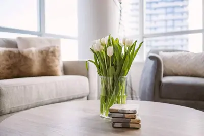 a vase of flowers sitting on a table at Skyline Waterfront 2BR plus 2BA wParking near MTCC in Toronto
