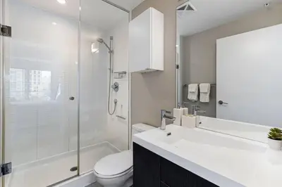 a bathroom with a sink and a toilet and a shower at Comfy 2 BR 2 BA Ent District Work from home in Toronto