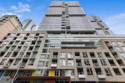 a tall building in front of some buildings at Comfy 2 BR 2 BA Ent District Work from home in Toronto