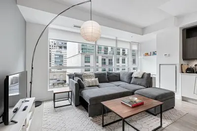 a living room with a couch and a table at Comfy 2 BR 2 BA Ent District Work from home in Toronto