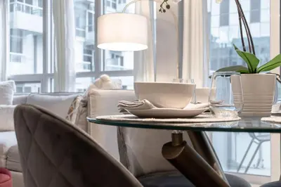 a table with a coffee cup on it in a living room at Stunning 1BR and Den Sleeps 6 Steps From CN Tower in Toronto