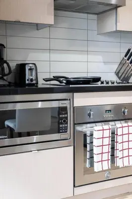 a kitchen with two ovens and a stove at 2BR Fantastic View of CN Tower and Roger Centre in Toronto