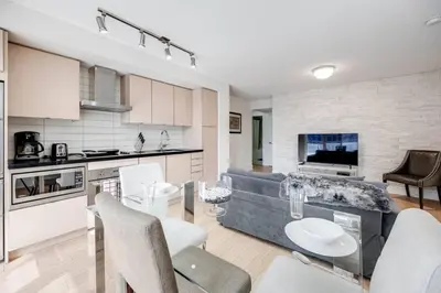 a kitchen and living room with a table and chairs at 2BR Fantastic View of CN Tower and Roger Centre in Toronto